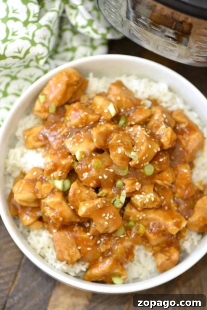 Delicious Spicy Honey Instant Pot Chicken Thighs: A Quick & Flavorful Pressure Cooker Recipe Spicy Honey Instant Pot Chicken Thighs served over rice, garnished with green onions and sesame seeds