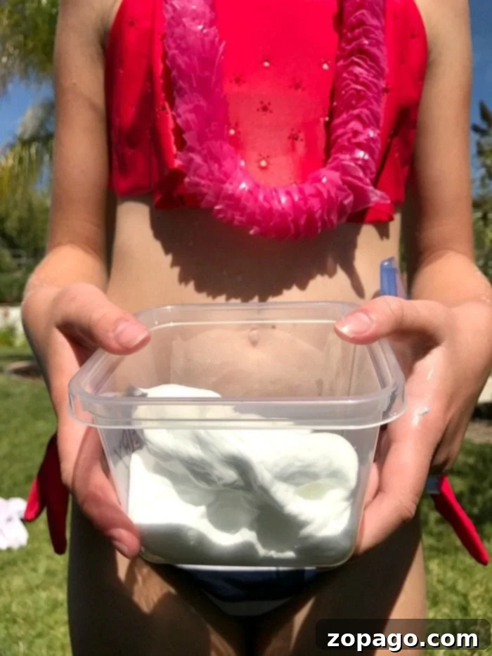 Engaging outdoor activities like water games and slime creation make for the perfect slime birthday party, ensuring endless fun for kids! #slimebirthdayparty #slime #birthdayparty #party #birthday #boy #girl #games #activities Kids playing with water balloons and sprinklers at a vibrant outdoor party