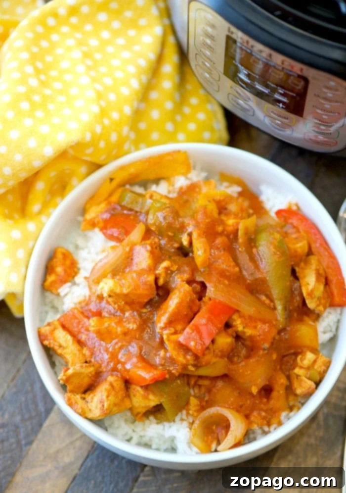Instant Pot chicken cacciatore recipe: so easy, 3 minutes to cook, moist and flavorful with just 3 ingredients. A low-carb dinner favorite served over rice. Healthy and affordable! A serving of Instant Pot chicken cacciatore over a bed of fluffy white rice on a vibrant yellow polka dot tablecloth.