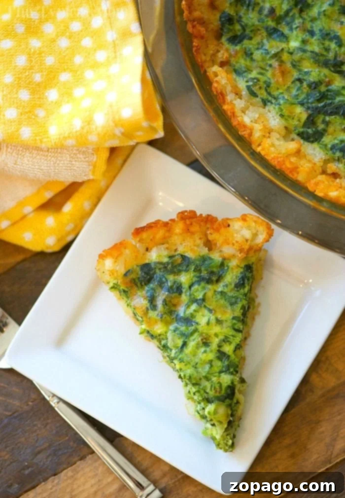 Tater Tot Crusted Spinach Quiche: A delightful and satisfying dish for any meal. Close-up of a slice of tater tot crusted spinach quiche, showing the layers of crispy crust and creamy filling