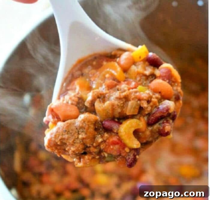 Bowl of Ninja Foodi Chili with cheese and sour cream toppings