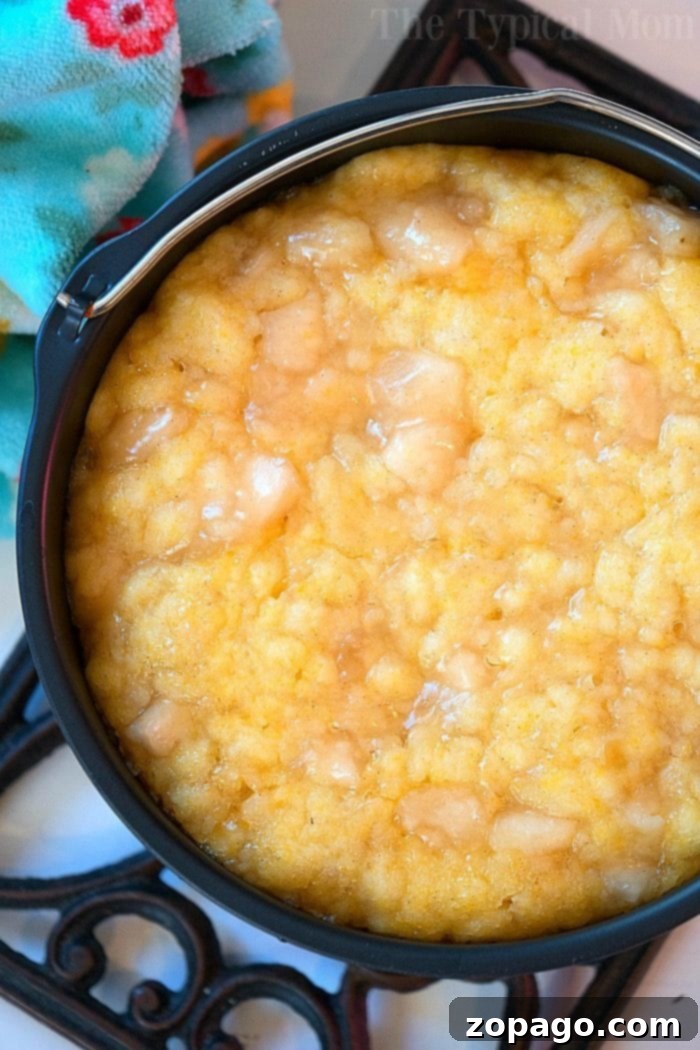 Easy Instant Pot Dump Cake 4 Warm, creamy instant pot dump cake, placed on a decorative trivet, ready to be served.