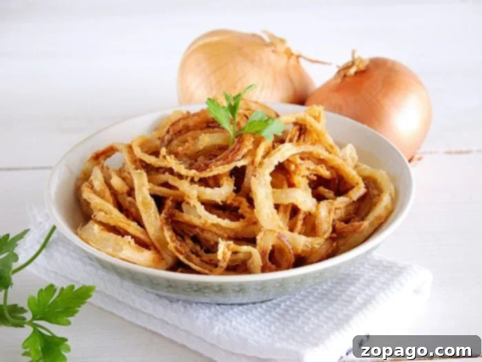 Homemade Crispy Fried Onions for Topping. A bowl of homemade french fried onions, perfectly golden and crispy.