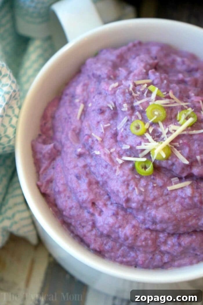 Velvety Instant Pot Cauliflower 2 Vibrant purple Instant Pot cauliflower mash served in a bowl, garnished with fresh herbs, showcasing a healthy and colorful side dish.