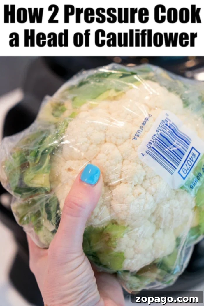 Velvety Instant Pot Cauliflower 4 Close-up of steamed pressure cooker cauliflower florets in a steamer basket, ready to be mashed into a creamy dish.