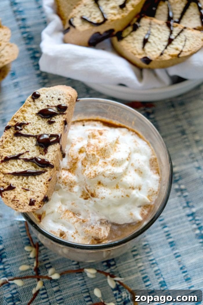 How to Make Hot Chocolate from Scratch and Spiked – The Ultimate Winter Comfort A steaming mug of rich homemade hot chocolate, topped with whipped cream, sitting on a rustic wooden table, evoking warmth and comfort.