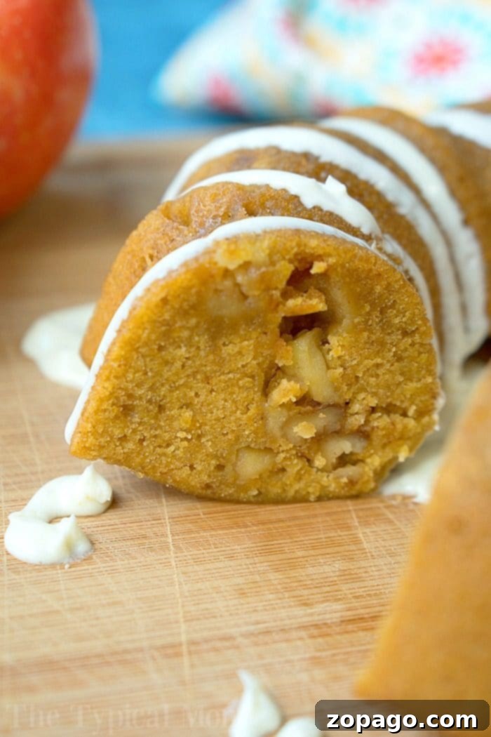 Deliciously moist Instant Pot pumpkin apple cake, ready to be enjoyed. A freshly baked Instant Pot pumpkin apple cake, drizzled with vanilla frosting.