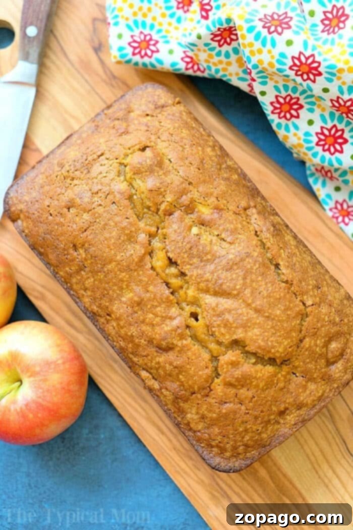 Easy pumpkin apple bread recipe that's a perfect breakfast or dessert for Fall! Moist pumpkin bread packed with diced apples and nuts is our favorite treat. Easy pumpkin apple bread, perfect for fall, with a golden crust and a hint of apples.