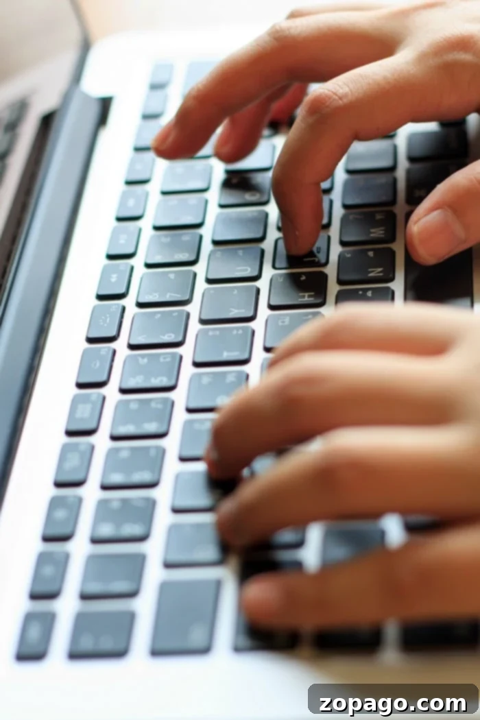 Property management for rental homes typing on laptop