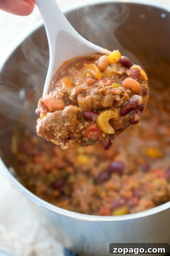 This easy bloody mary chili recipe is thick and packed with flavor! If you love this classic drink or just love chili you've got to try this hearty meal. Large pot of Bloody Mary Chili simmering on the stovetop, rich in color and texture.