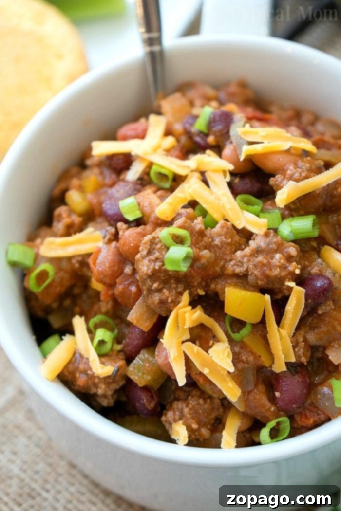 This easy bloody mary chili recipe is thick and packed with flavor! If you love this classic drink or just love chili you've got to try this hearty meal. Bloody Mary Chili served in a rustic bowl with toppings, ready to eat.