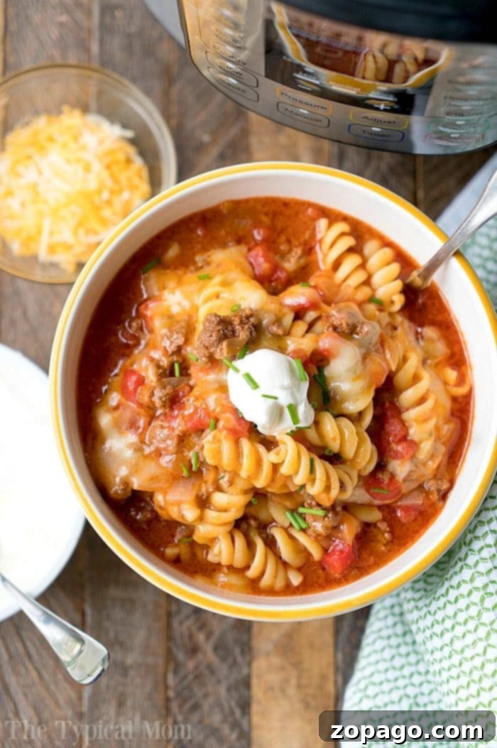 Easy Instant Pot pasta recipes to get you started with your pressure cooker! Simple soups and main dishes with pasta in them that we love. #instantpotrecipes #instantpot #ninjafoodirecipes #ninjafoodi #thetypicalmom #pasta A vibrant Instant Pot taco casserole, topped with melted cheese and fresh cilantro, illustrating a hearty and easy pressure cooker pasta meal.