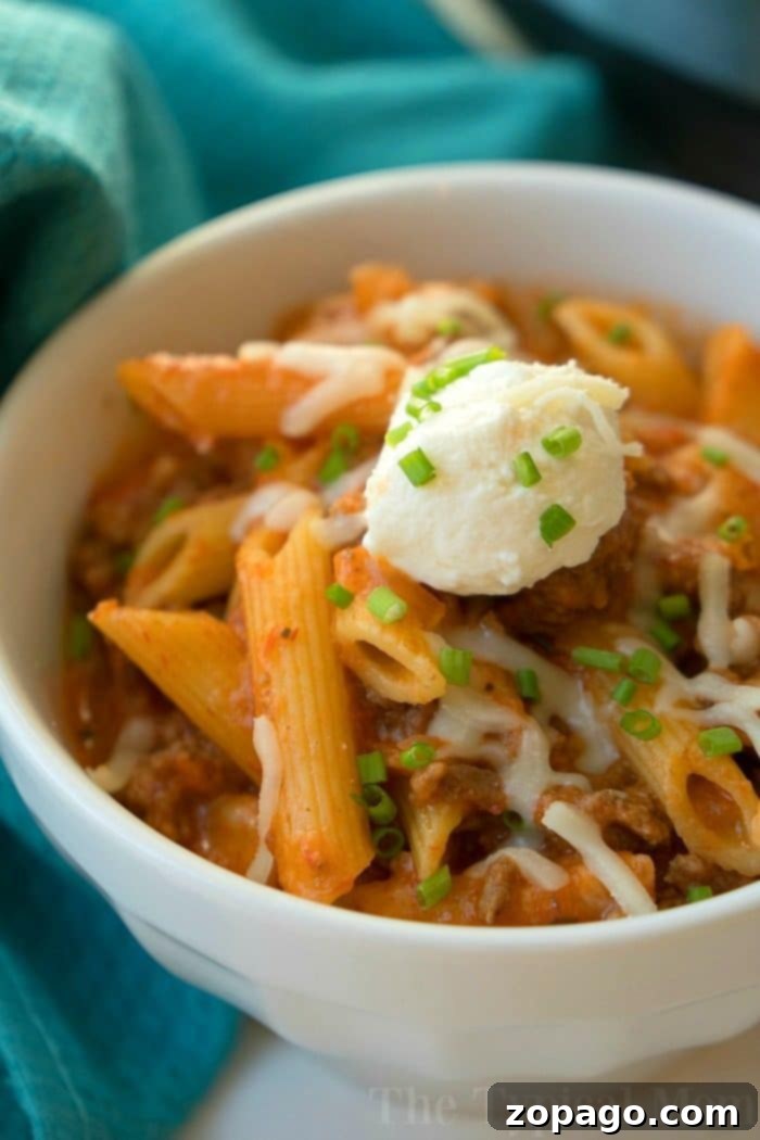 Instant Pot lasagna casserole recipe our whole family loves. Cheesy Instant Pot lasagna but in a casserole which makes it much easier to make! #instantpot #lasagna #casserole #pressurecooker #instantpotrecipes #thetypicalmom A delightful twist on a classic, this bowl of penne pasta is simmered to perfection like a pressure cooker lasagna, featuring savory meat sauce topped with cheese, ricotta cream, and fresh chives.