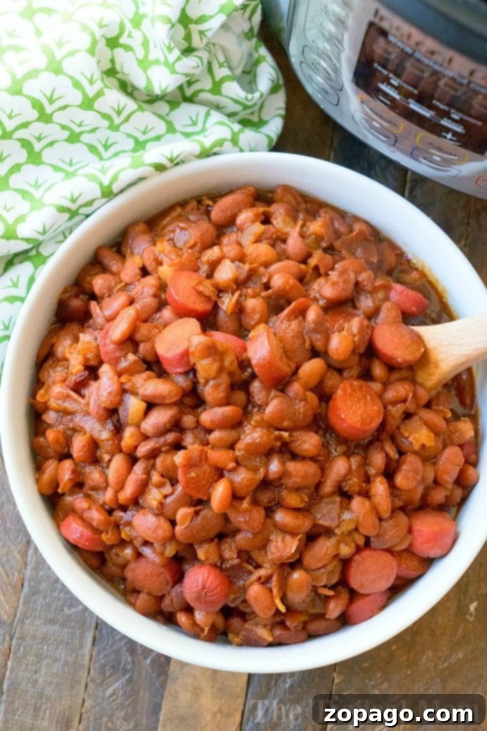 Hearty and cheap Instant Pot Beans and Franks, a kid-friendly meal. #instantpot #beansandfranks A bowl of Instant Pot Beans and Franks, a classic comfort food for a cheap and easy meal.