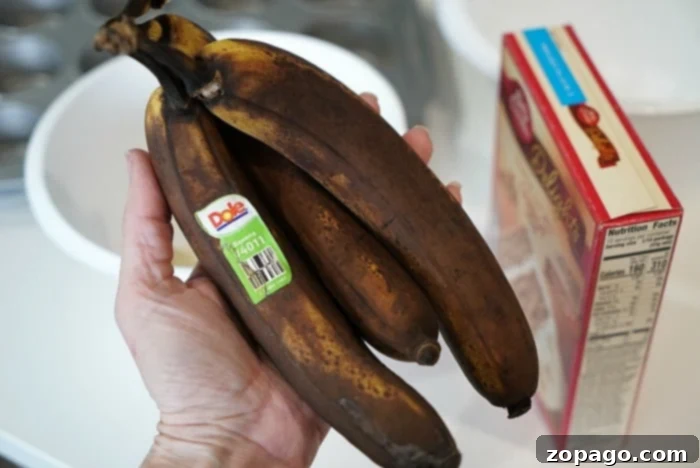 Ultimate Banana Pudding Cake 3 A person holds ripe bananas, poised to whip up a recipe, with a cake mix box conveniently nearby.