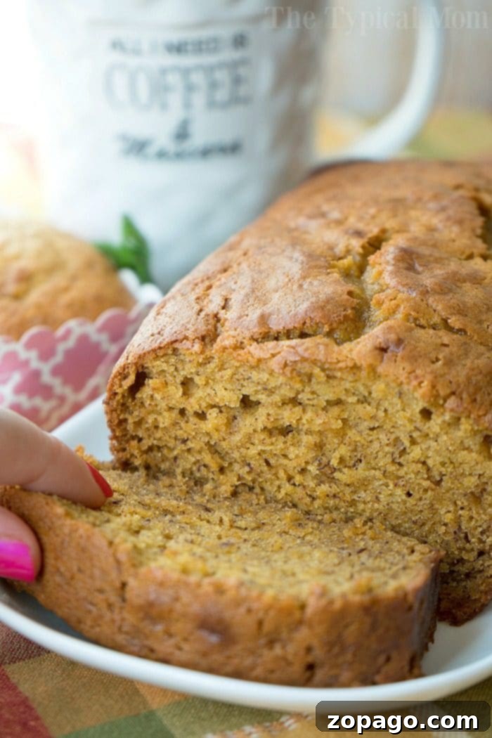 Pumpkin banana bread recipe is here! Perfect breakfast, brunch or dessert paired with a cup of coffee this holiday season or year round. If you love banana and pumpkin bread this is a great twist on your traditional sweet bread recipe. Perfect for any occasion. #folgers #banana #pumpkin #bread #recipe #overripe #bananas #recipes #moist A table setting with coffee, autumn leaves, and a loaf of pumpkin banana bread