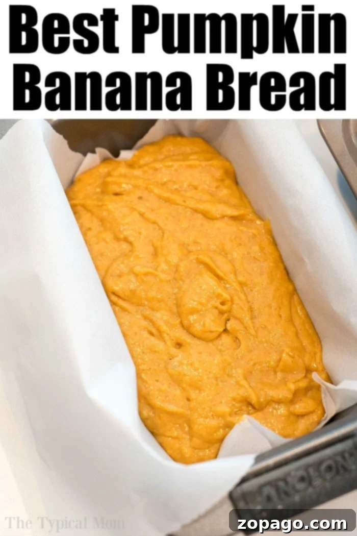 Banana pumpkin bread recipe! #pumpkin #banana #bread #loaf #muffins #pumpkinbanana A large, golden-brown loaf of pumpkin banana bread on a wooden cutting board