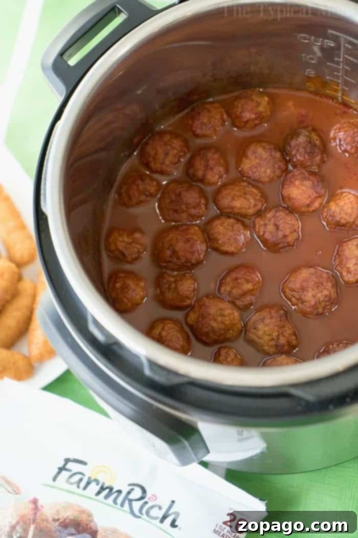 Instant Pot Barbecue Meatballs: Your Go-To Appetizer Large serving of Instant Pot barbecue meatballs in a silver pot, ready for a party.