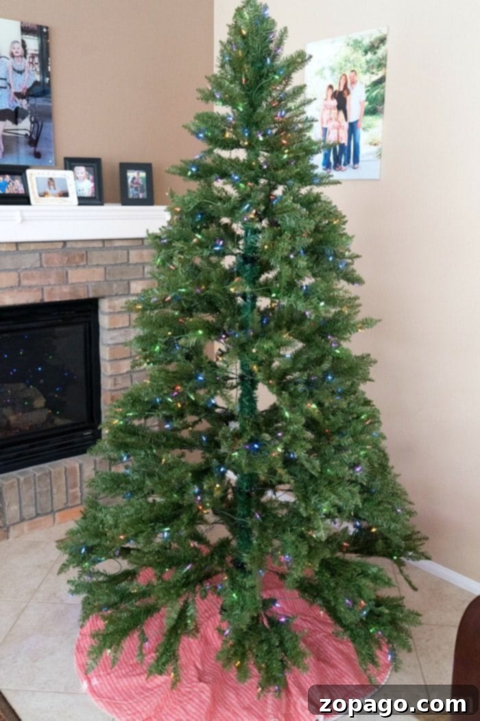 The perfect holiday centerpiece: a stunning artificial Christmas tree with easy assembly and beautiful lighting A beautifully decorated artificial Christmas tree with gifts underneath, showcasing its realistic branches and vibrant lights