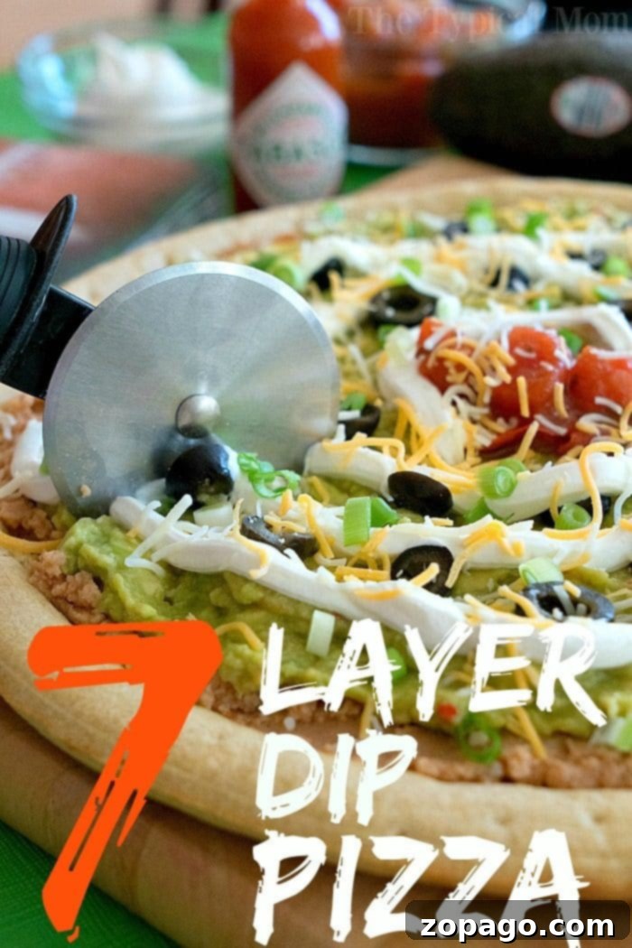 Loaded 7 Layer Pizza Dip 6 A vibrant 7 layer dip pizza with fresh ingredients, ready to be enjoyed.