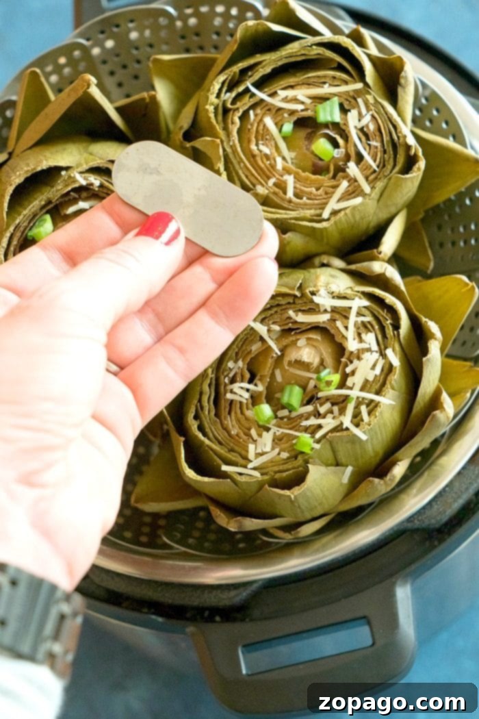 Easy Instant Pot artichokes with creamy dill dipping sauce ready in less than 15 minutes! How to steam artichokes in your pressure cooker to perfection. Our favorite vegetable for dinner and a healthy side dish too. #instantpot #pressurecooker #vegetables #artichokes #artichoke #instantpotrecipes #thetypicalmom #vegetarian Easy Instant Pot Artichokes with a creamy dill dip