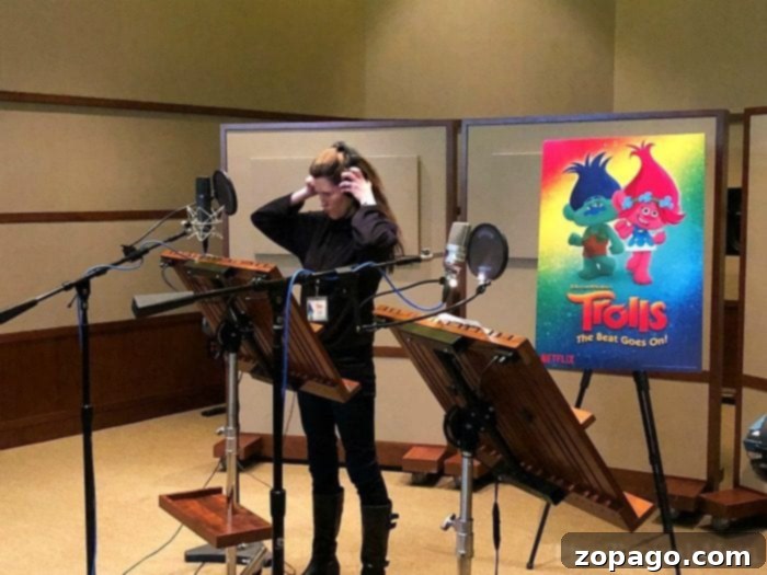 Experience the thrill of voice acting for your favorite Trolls character, Branch. Person in a sound booth doing voice-over for Trolls character