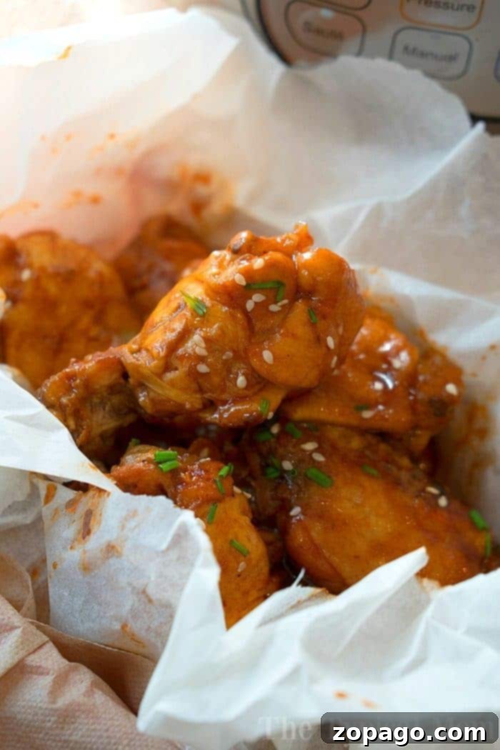 Effortless Pressure Cooker Frozen Chicken Wings 3 Close-up of perfectly cooked Instant Pot frozen chicken wings coated in a rich barbecue sauce, ready to be served.