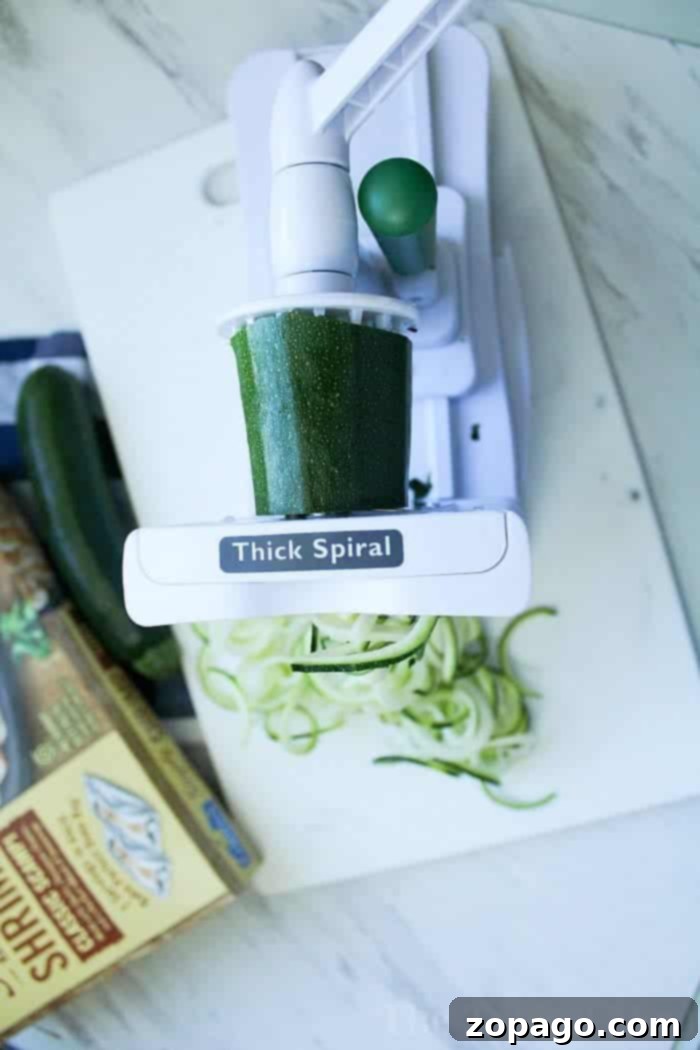 This is how you make zucchini noodles and shrimp casserole! This simple seafood dinner idea is a favorite at our house substituting vegetable noodles instead of traditional pasta. If you've never made zucchini zoodles before you are in for a real treat. Buttery and cheesy you'll love this family meal. How to Make Zucchini Noodles using a spiralizer for a healthy, low-carb meal.