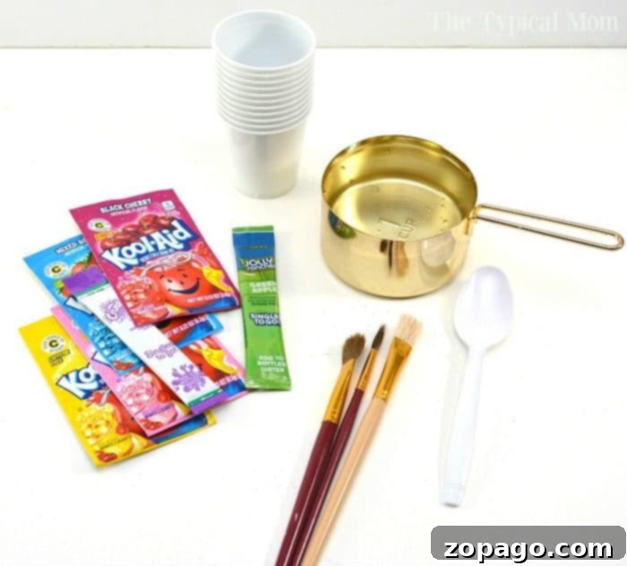 This is how easy it is to make Kool Aid paint so your kids can watercolor safely at home! A fun and inexpensive craft for kids that is easy to put together. Free from chemicals it's a great activity for Preschool children and toddlers too! Painting has never been so fun, and yummy too. #kidscrafts #preschool #toddler #craft #safe #paint #painting #safe #paints #homemade #koolaid #watercolor Three cups filled with vibrant Kool-Aid paint in blue, red, and yellow, with paintbrushes resting inside.