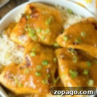 Instant Pot Honey Mustard Chicken with green onions served over rice in a white bowl.