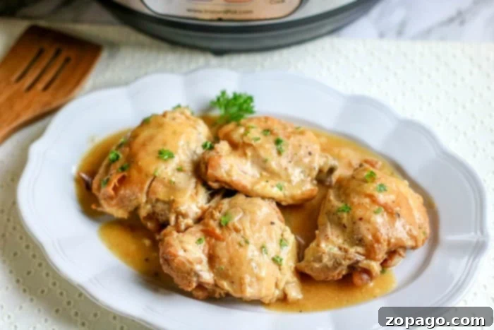 Quick Instant Pot Honey Mustard Chicken 7 Close-up of pressure cooker boneless chicken thighs in a delicious sauce, ready to be served, highlighting their golden brown exterior and tender texture.
