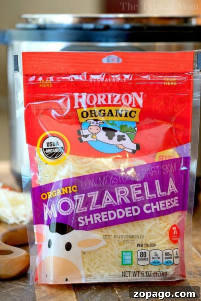 Easy Instant Pot Pizza 10 A slice of Instant Pot deep-dish pizza, laden with pepperoni, cheese, and olives, is lifted from the pan, revealing its thick, golden crust. The background shows the remaining pizza in the pan.