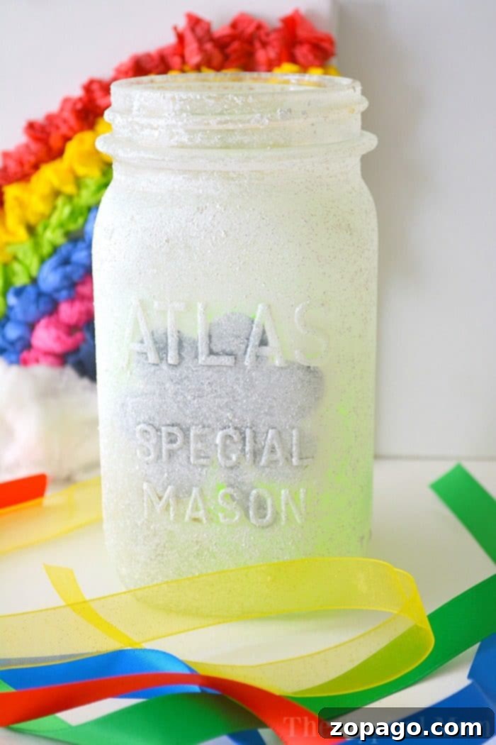 St. Patrick's Day Mason Jar Luminary: A fun and easy craft for kids and festive decor. A festive St. Patrick's Day themed mason jar luminary glowing with a shamrock design.