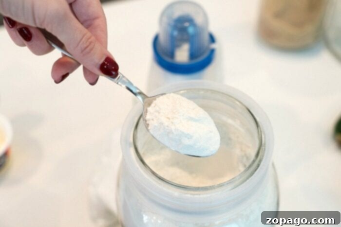 How to Make Self-Rising Flour Ingredients for making homemade self-rising flour, including all-purpose flour, baking powder, and salt, measured out on a counter.