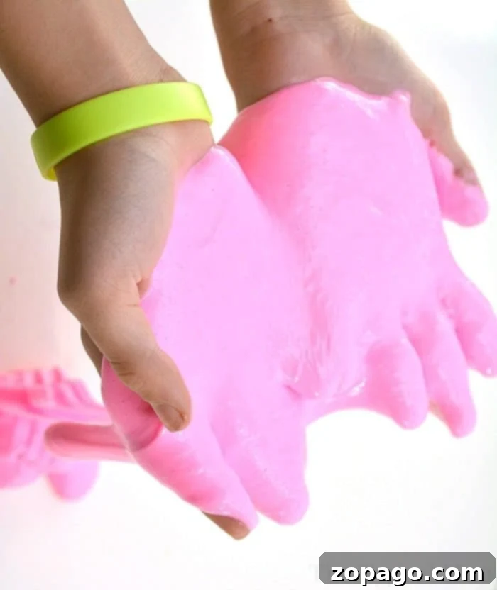 Stretchy Glow Slime Craft Close-up of pink glow in the dark slime being stretched