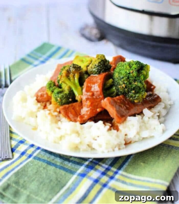 Weeknight Pressure Cooker Beef and Broccoli 2 Pressure Cooker Beef and Broccoli dish in a bowl over rice.