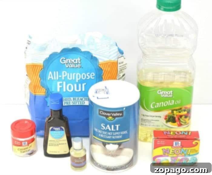 Fragrant Playdough 3 Ingredients laid out on a table: flour, salt, cream of tartar, water, oil, essential oils, and vanilla extract.