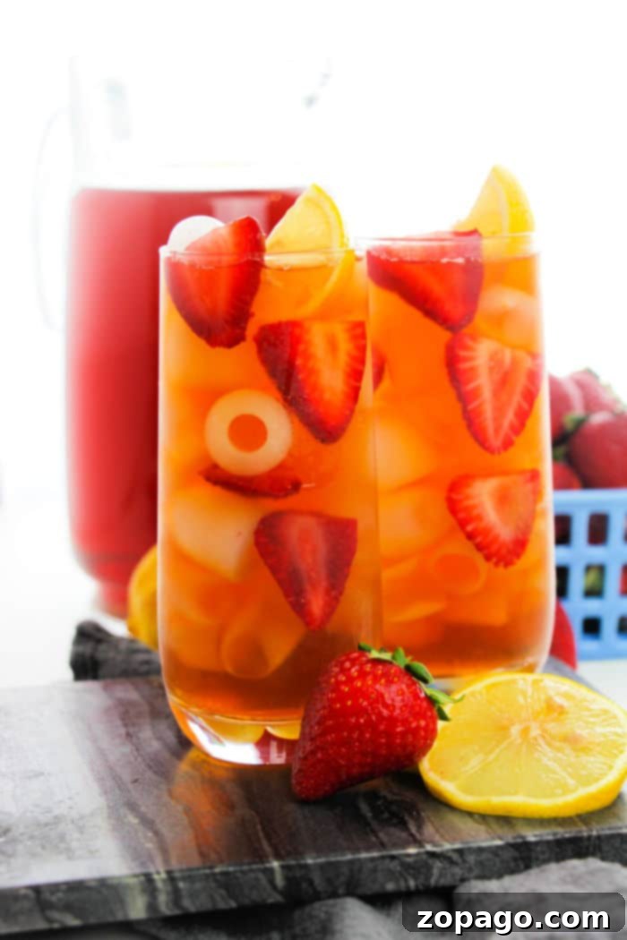 Blueberry Bliss 4 A refreshing glass of blueberry sweet tea, garnished with fresh berries and mint, perfect for a summer day.