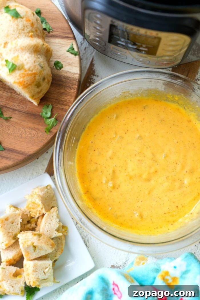 Easy Pressure Cooker Cheese Fondue Pressure Cooker Cheese Fondue with dipping bread slices and vegetables.