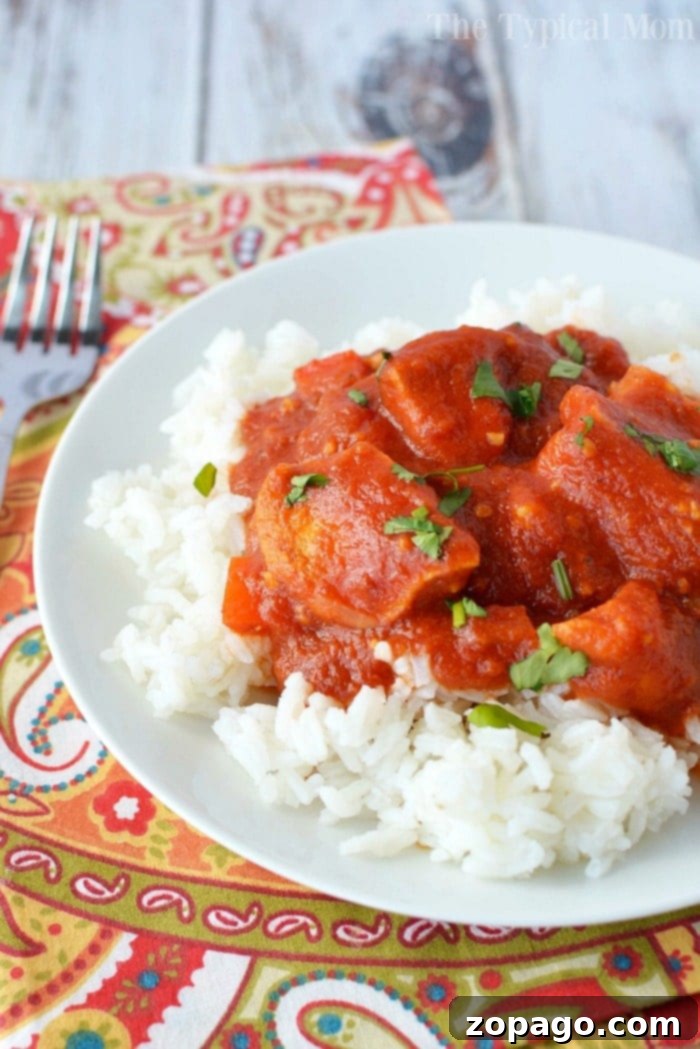 Enjoy a healthy butter chicken recipe made effortlessly in your slow cooker or quickly in a pressure cooker. This traditional Indian dish is easy to prepare at home, full of flavor, and perfect over rice or with naan. #healthy #indian #butterchicken #chicken #crockpot #slowcooker #easy Healthy Butter Chicken Recipe in a slow cooker with chicken pieces and sauce