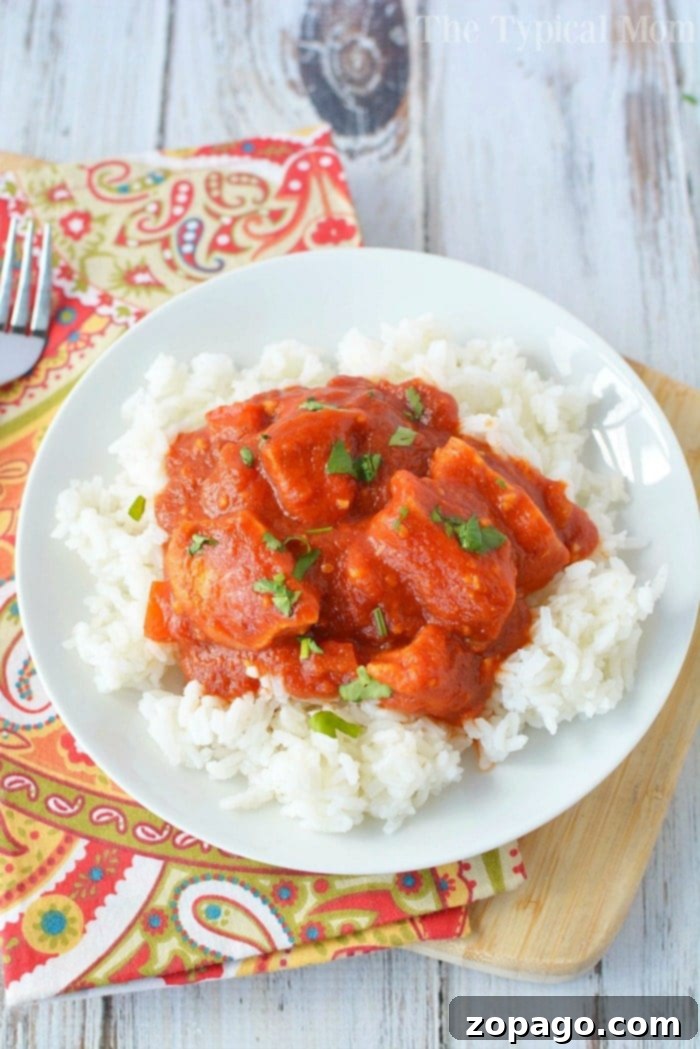 A healthy butter chicken recipe that can be made in a slow cooker or quickly in a pressure cooker. Enjoy this easy, traditional Indian dish at home for dinner, packed with flavor and perfect over rice or with naan. A true family favorite! #healthy #indian #butterchicken #chicken #crockpot #slowcooker #easy Healthy Butter Chicken Recipe with fresh cilantro