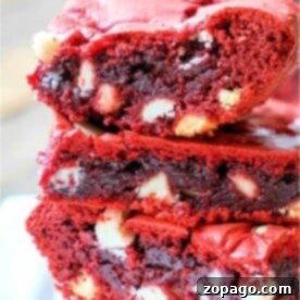 A stack of moist red velvet brownies from cake mix, rich in color and texture, with visible white chocolate chips.