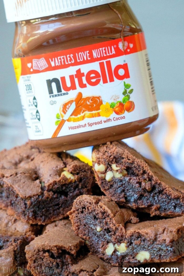 Brownies from cake mix Devils food variety are amazing. If you've never made Nutella brownies out of cake mix let me show you what you've been missing! #cakemix #brownies #nutella Close-up of freshly baked, fudgy Devil's Food cake mix brownies with Nutella swirl.