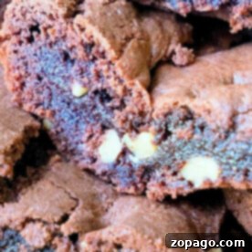 Close-up of decadent chocolate brownies made from devil's food cake mix, with visible chunks of nuts inside.