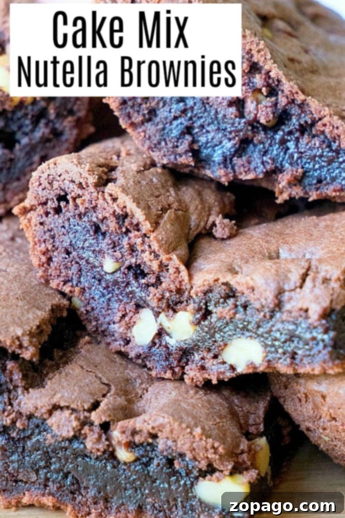 Brownies from cake mix Devils food variety are amazing. If you've never made Nutella brownies out of cake mix let me show you what you've been missing! #cakemix #brownies #nutella Close-up of a square of rich, fudgy Devil's Food cake mix brownie with a Nutella swirl, on a white plate.