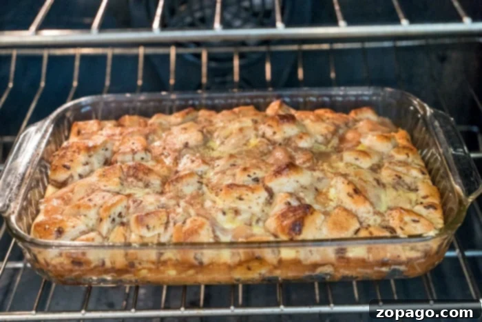 Gooey Cinnamon Roll Bake 3 Golden apple breakfast casserole, adorned with a sweet glaze, ready to be enjoyed.