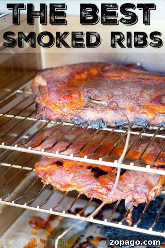 Smoky, Tender Ribs 5 Smoked ribs cooking in smoker, topped with seasoning and a meat thermometer inserted—truly the best way to smoke ribs to perfection.