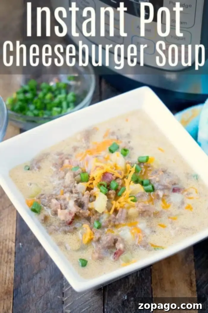 Instant Pot Keto Cheeseburger Soup 7 A square white bowl cradles a hearty instant pot cheeseburger soup, brimming with ground beef, melted cheese, diced tomatoes, and fresh green onions. In the background, chopped green onions await in a clear bowl beside the familiar curves of an Instant Pot.