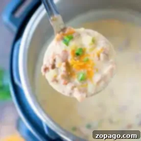 A ladle filled with creamy, instant pot cheeseburger soup brimming with chopped green onions, shredded cheese, and small meat chunks hovers above an Instant Pot filled with the same delicious soup. The edge of a cutting board showcasing extra toppings peeks in the background.