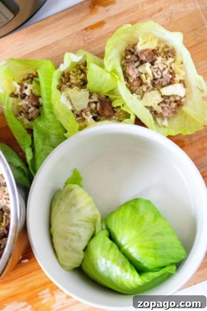 This Instant Pot stuffed cabbage is a great dinner filled with ground beef, rice, cheese and tons of flavor. Just a few minutes in your pressure cooker! #instantpot #instantpotrecipes #stuffedcabbage #cabbage Instant Pot Stuffed Cabbage